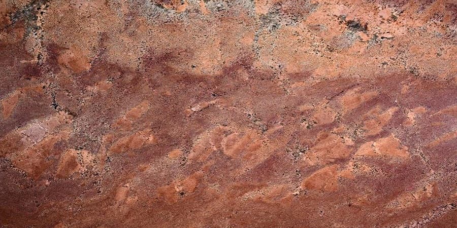 Juparana Bordeaux granite worktop with flowing red and grey veining